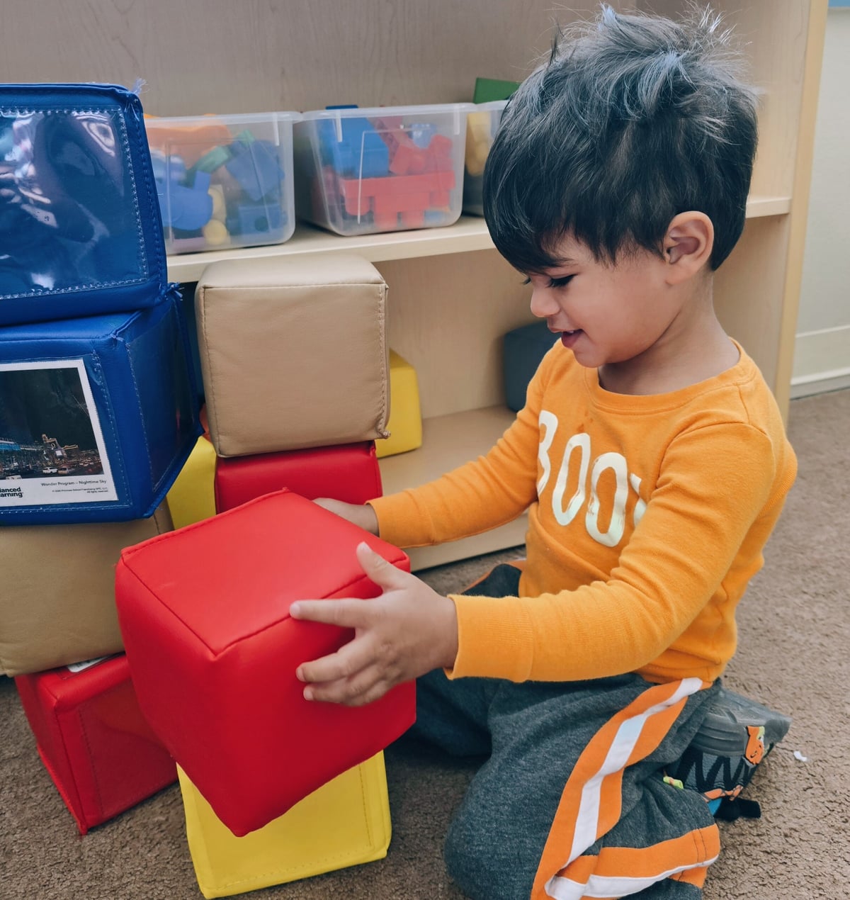 Toddler boy playing in the blocks center at Primrose School at Heritage in Keller, TX