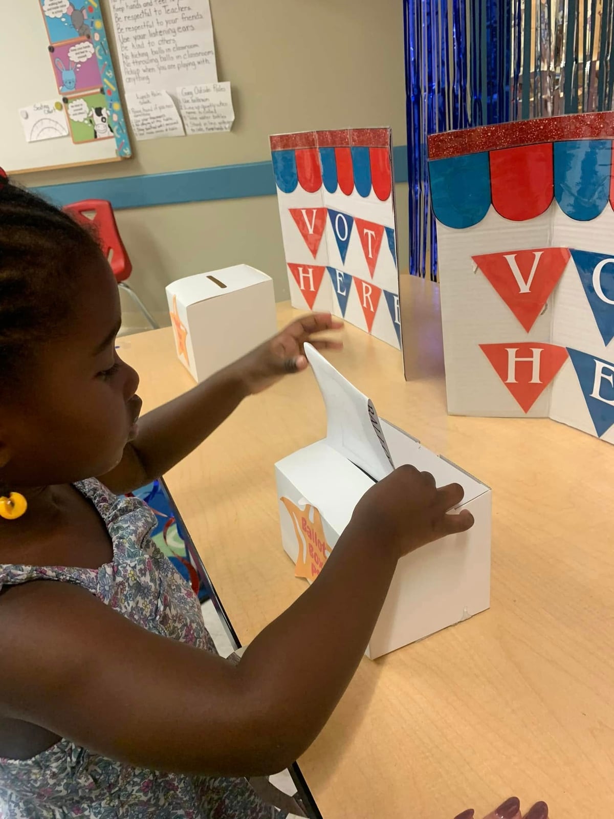 child casting a ballot