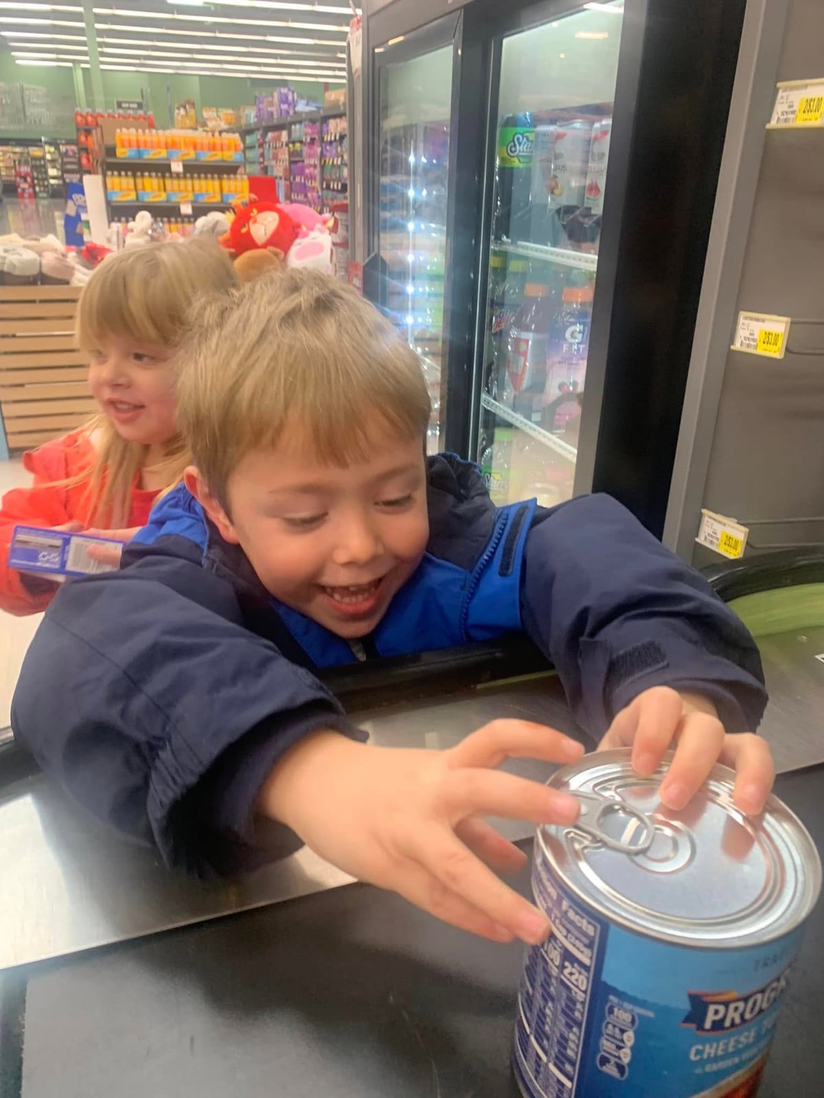 child selecting canned food