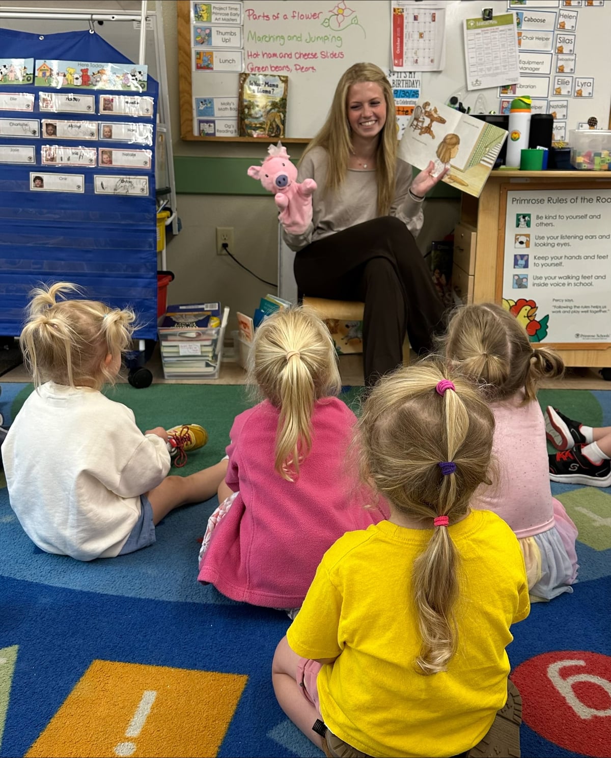 Teacher Halle leading storytime with puppet and book for preschoolers at Primrose School of Eagan preschool in Eagan, MN