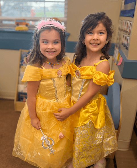2 girls wearing princess dress for book character day