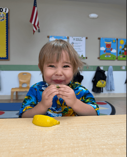 boy trying a lemon and lime making sour faces