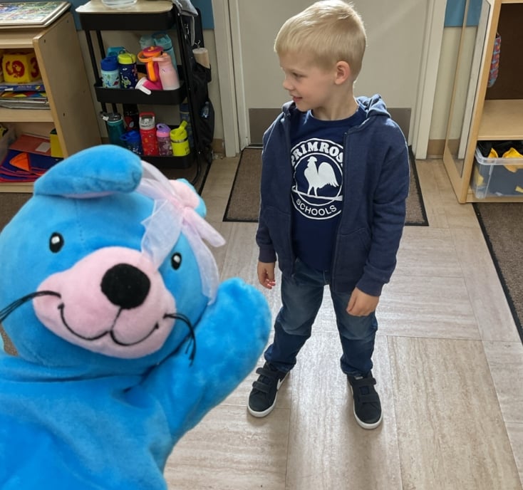 Preschool student participating in a social-emotional learning activity that encourages friendship, confidence, and positive classroom interactions.