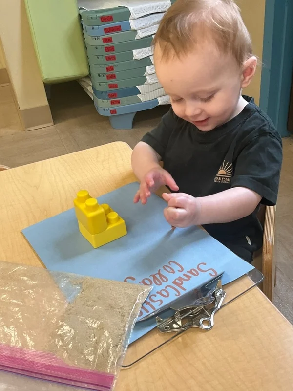 child exploring sand