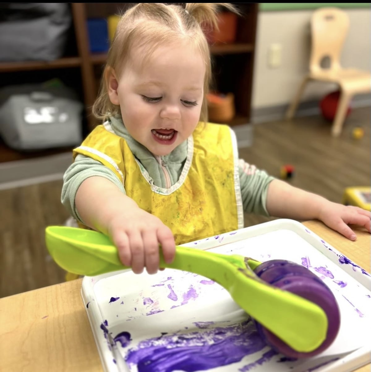 Toddler using paint roller