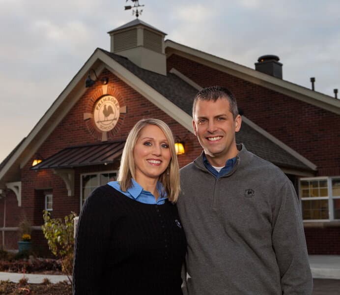 Diane and Darren Storkamp, owners of Primrose School of Eagan since 2011, standing in front of their Cognia-accredited childcare and preschool in Eagan, MN