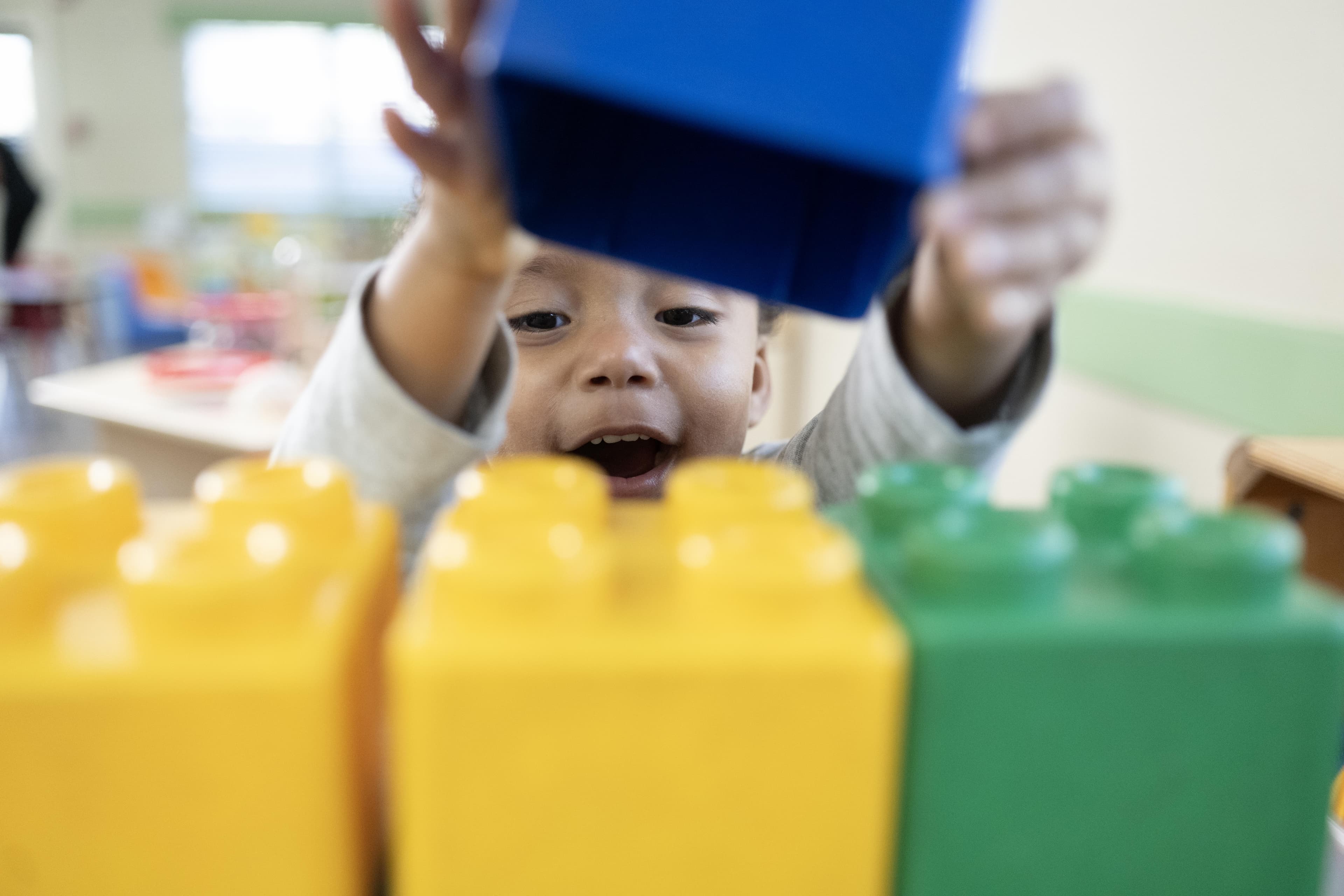 A boy playing with giant lego blocks