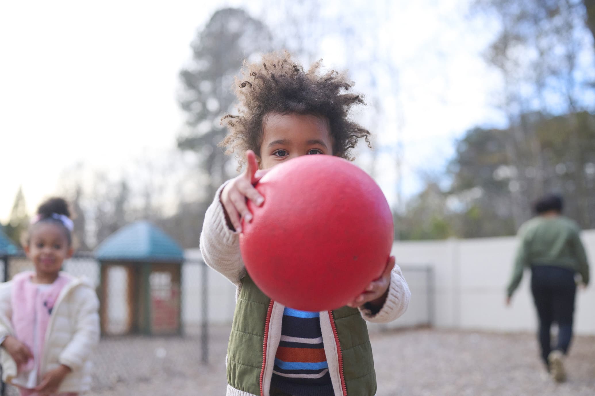 child holding a ball