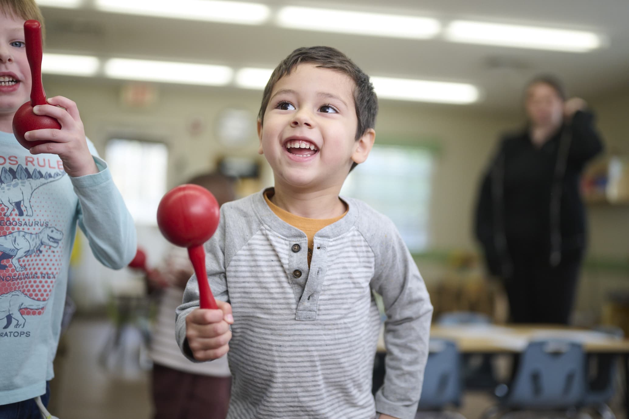 preschool child holding maraca
