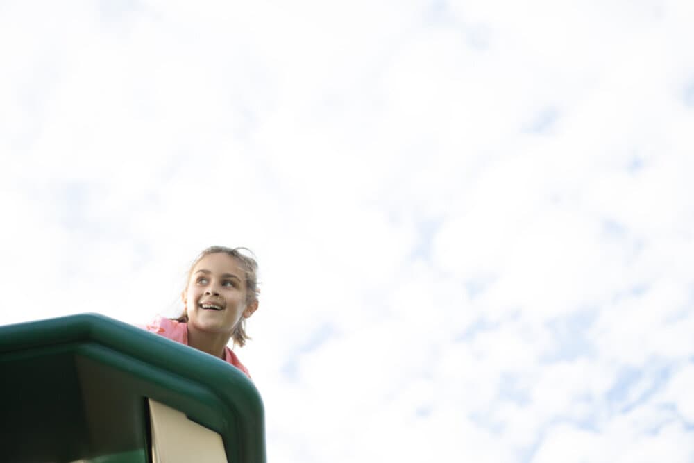 child on playground slide