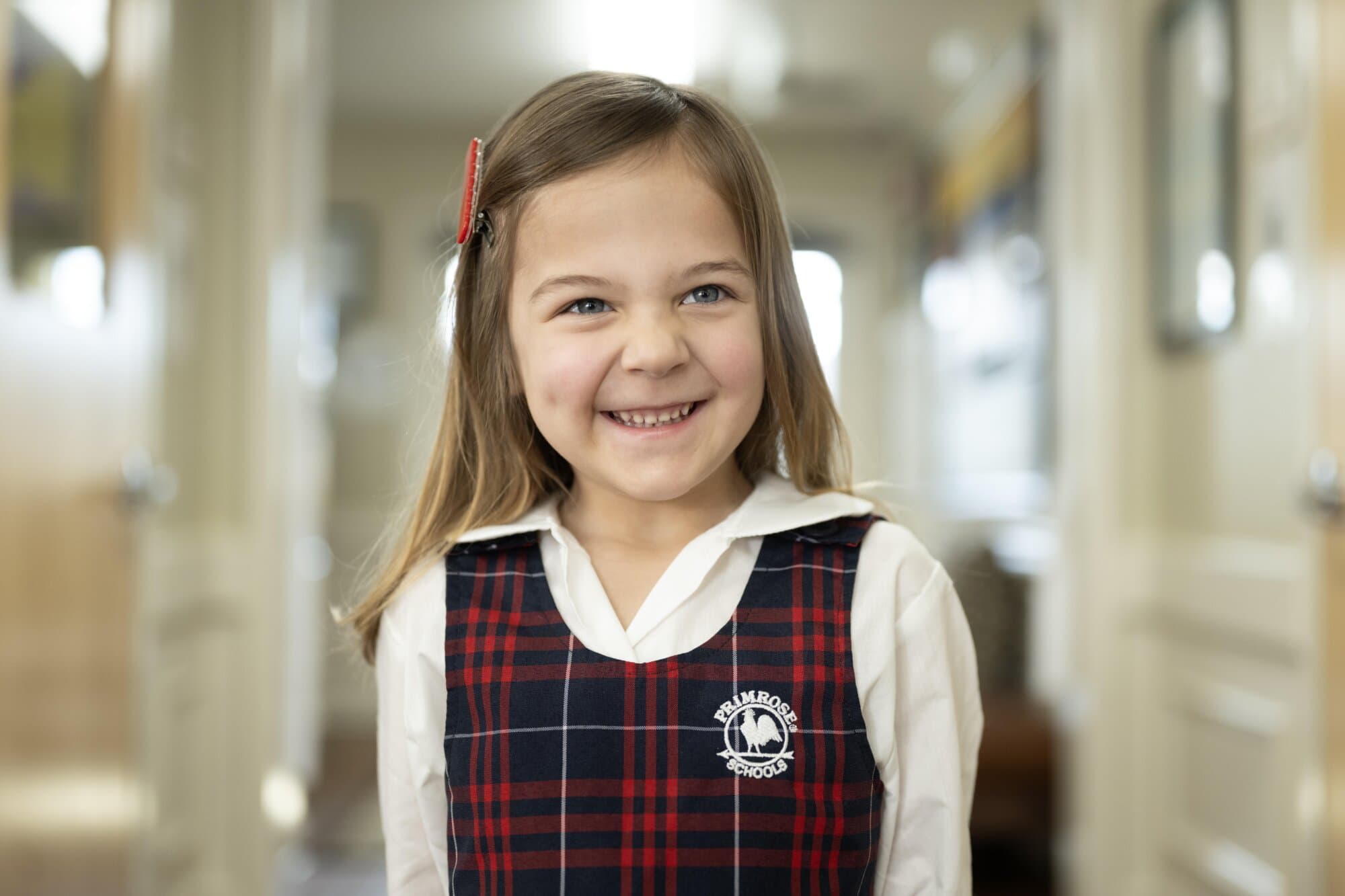 pre-k child smiling in a primrose uniform