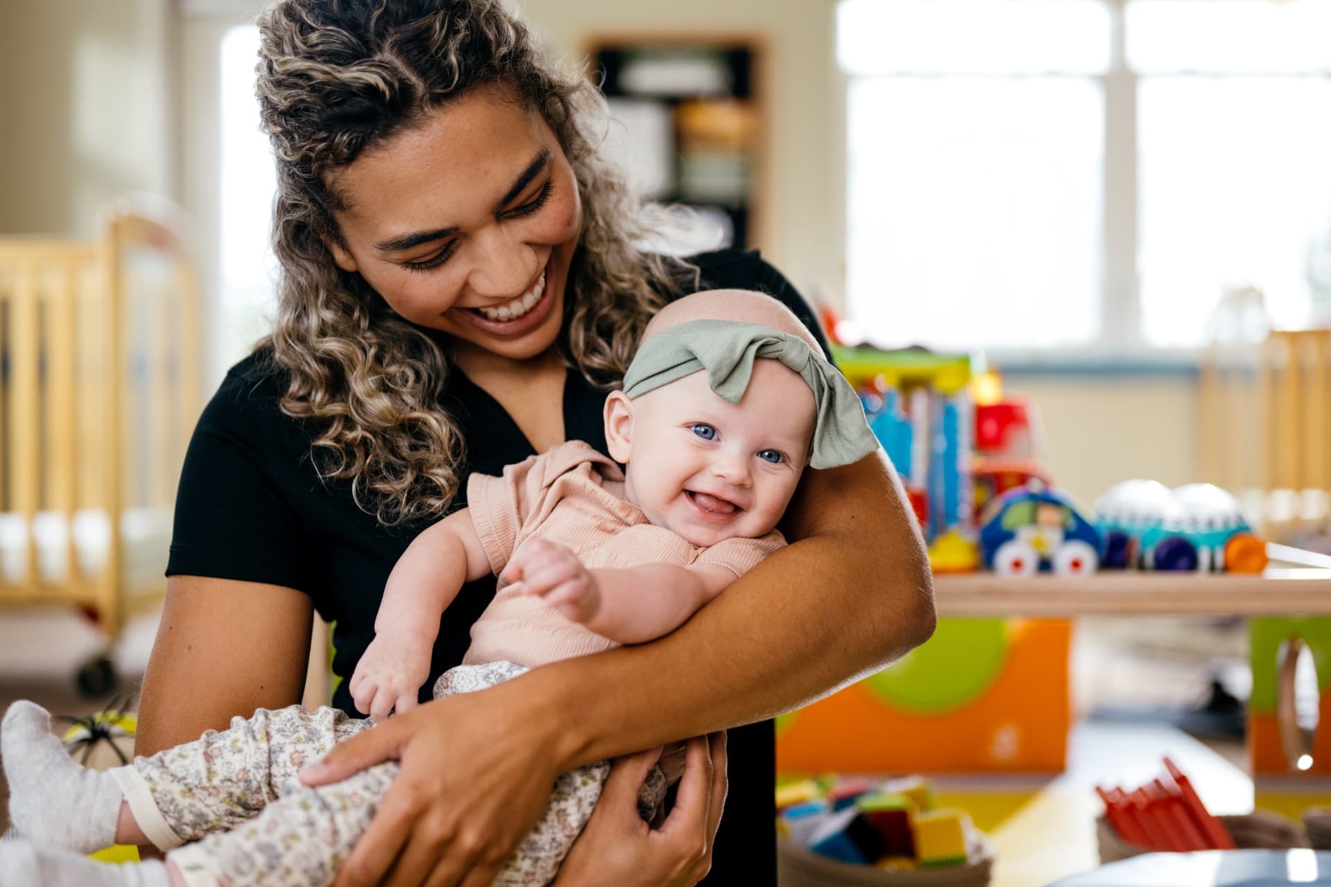 Primrose teacher holding infant