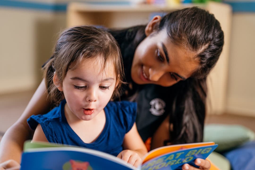 Primrose teacher reading to toddler