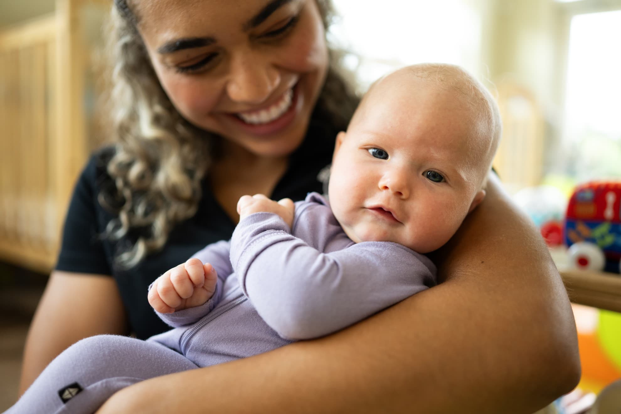 Infant being held by Primrose teacher