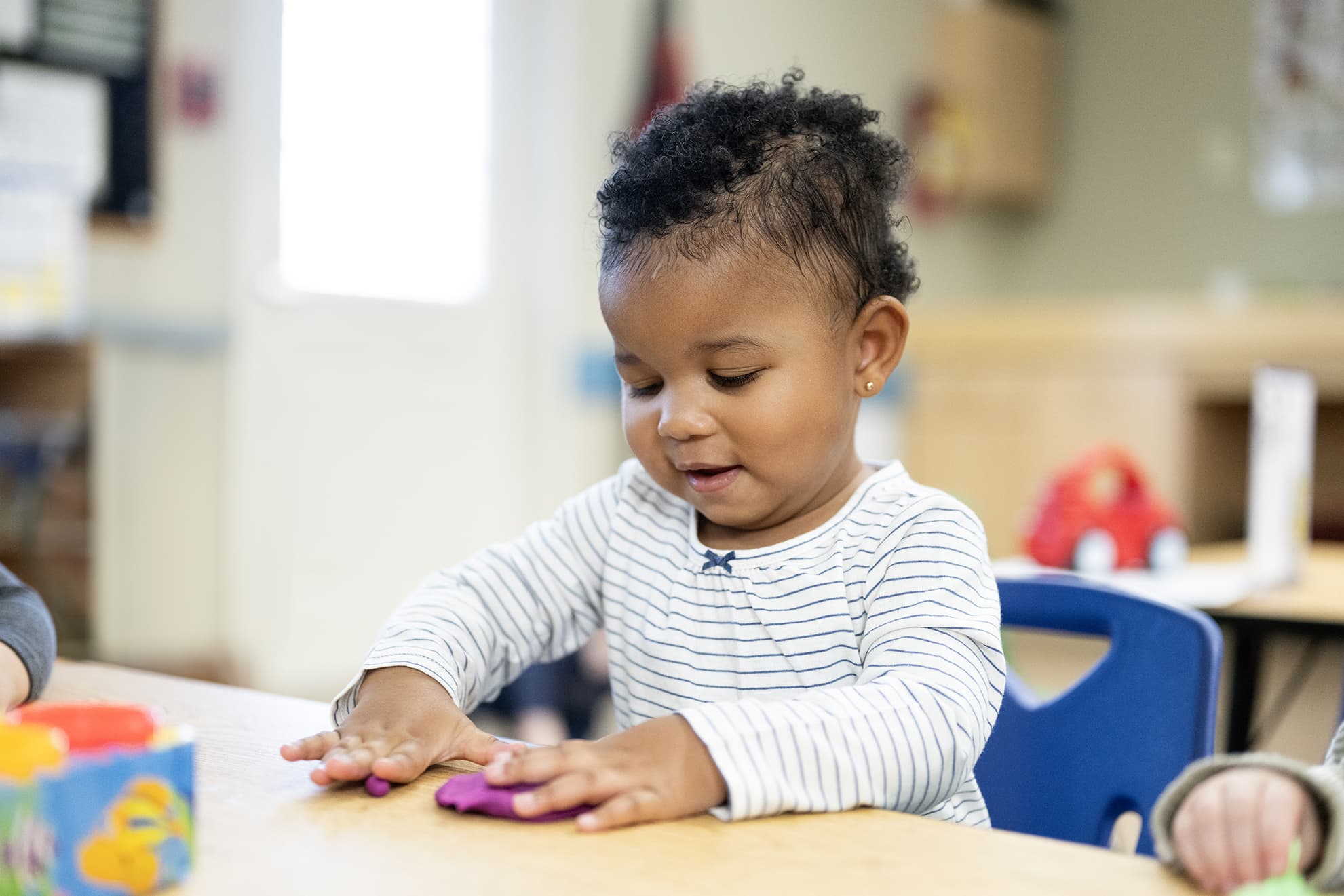 toddler playing with play-doh