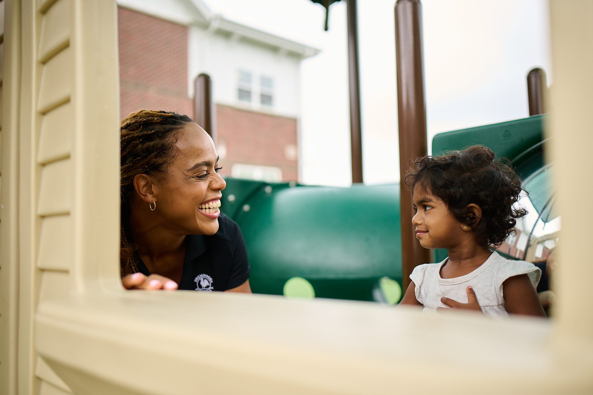 Primrose teacher playing on the playground with toddler class