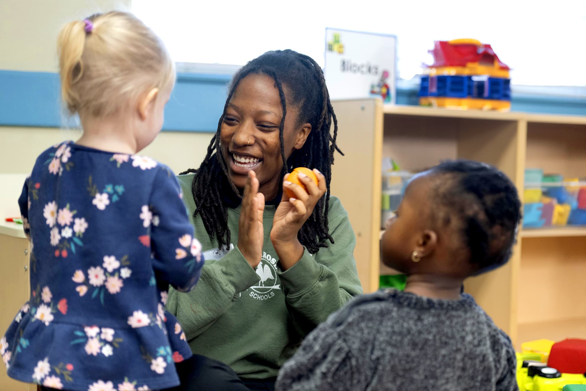 toddler teacher interacting with class