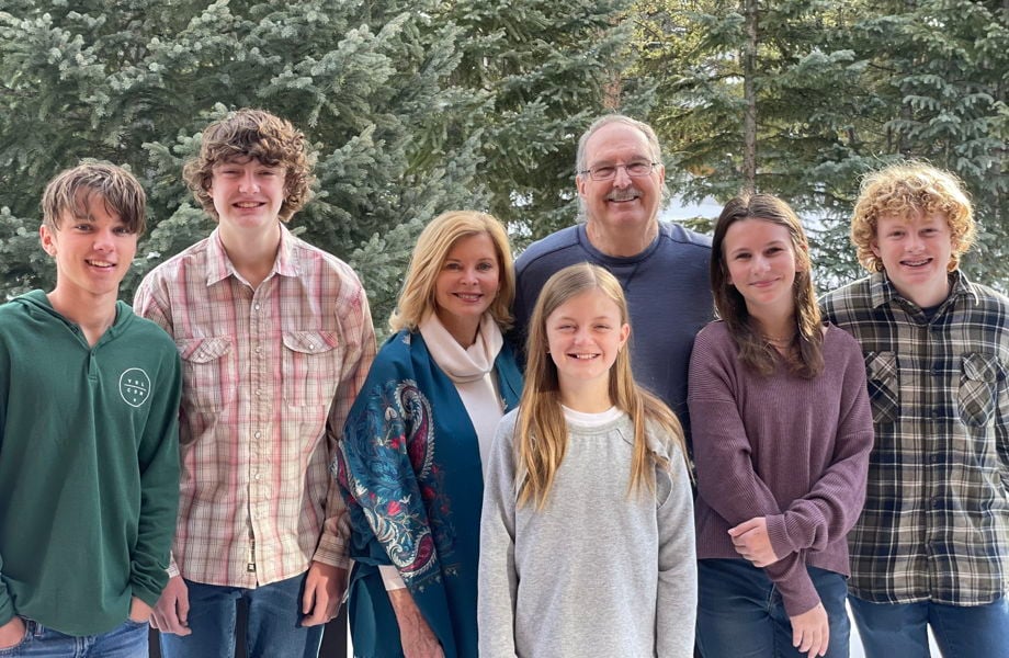 Five teenaged children with two grandparents all smiling forward