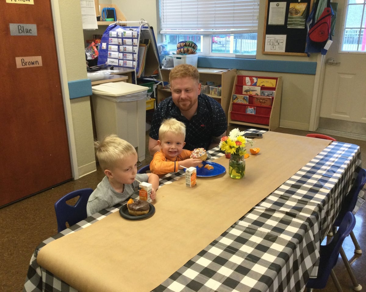 Dad and his 2 boys eating