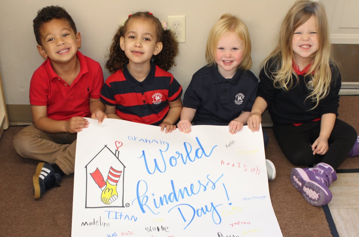 Children holding a World Kindness sign