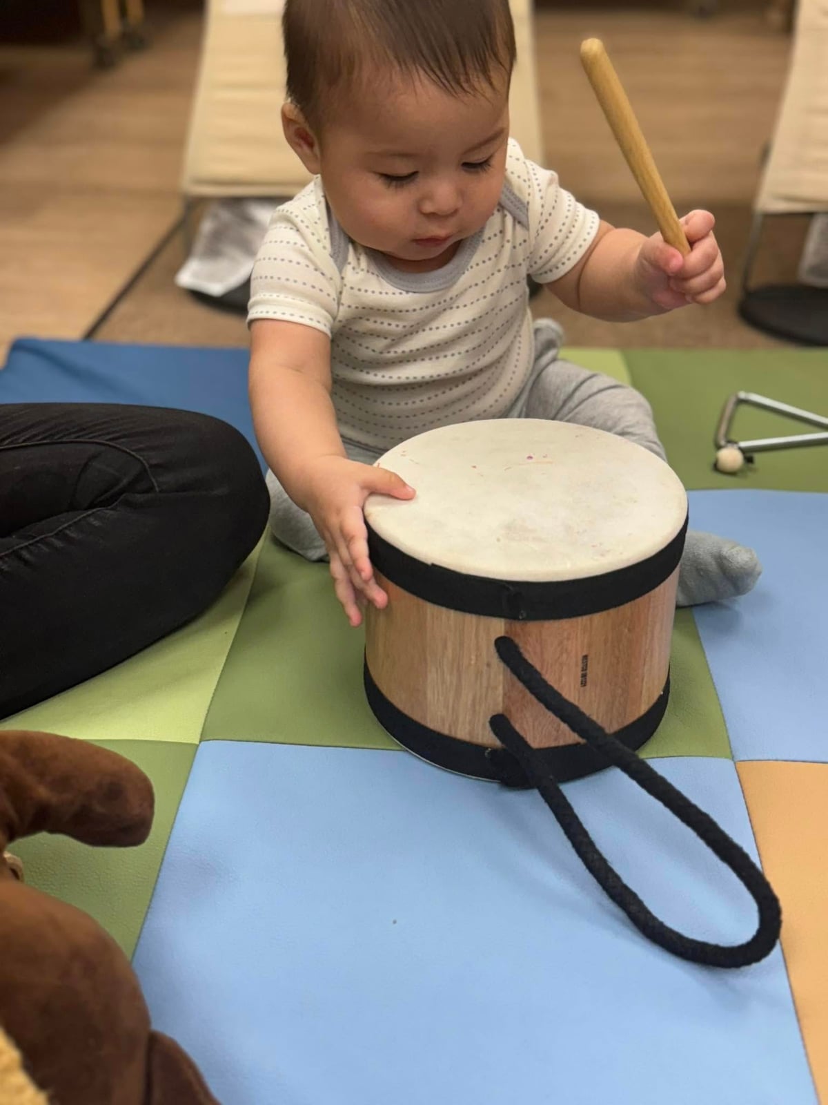 a baby playing a drum