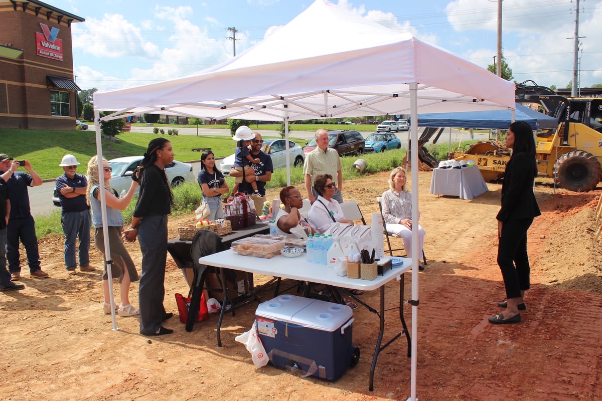 image shows members of the community participating in the groundbreaking ceremony