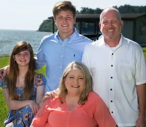 Primrose Owners Andrea and John Schoel and Family in front of lake