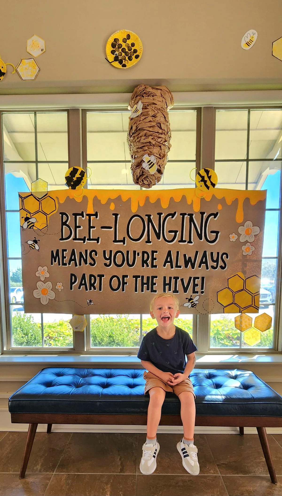 Preschool student excited to see their art work as part of our Belongingness Project at a Keller daycare, building creativity and confidence in the classroom
