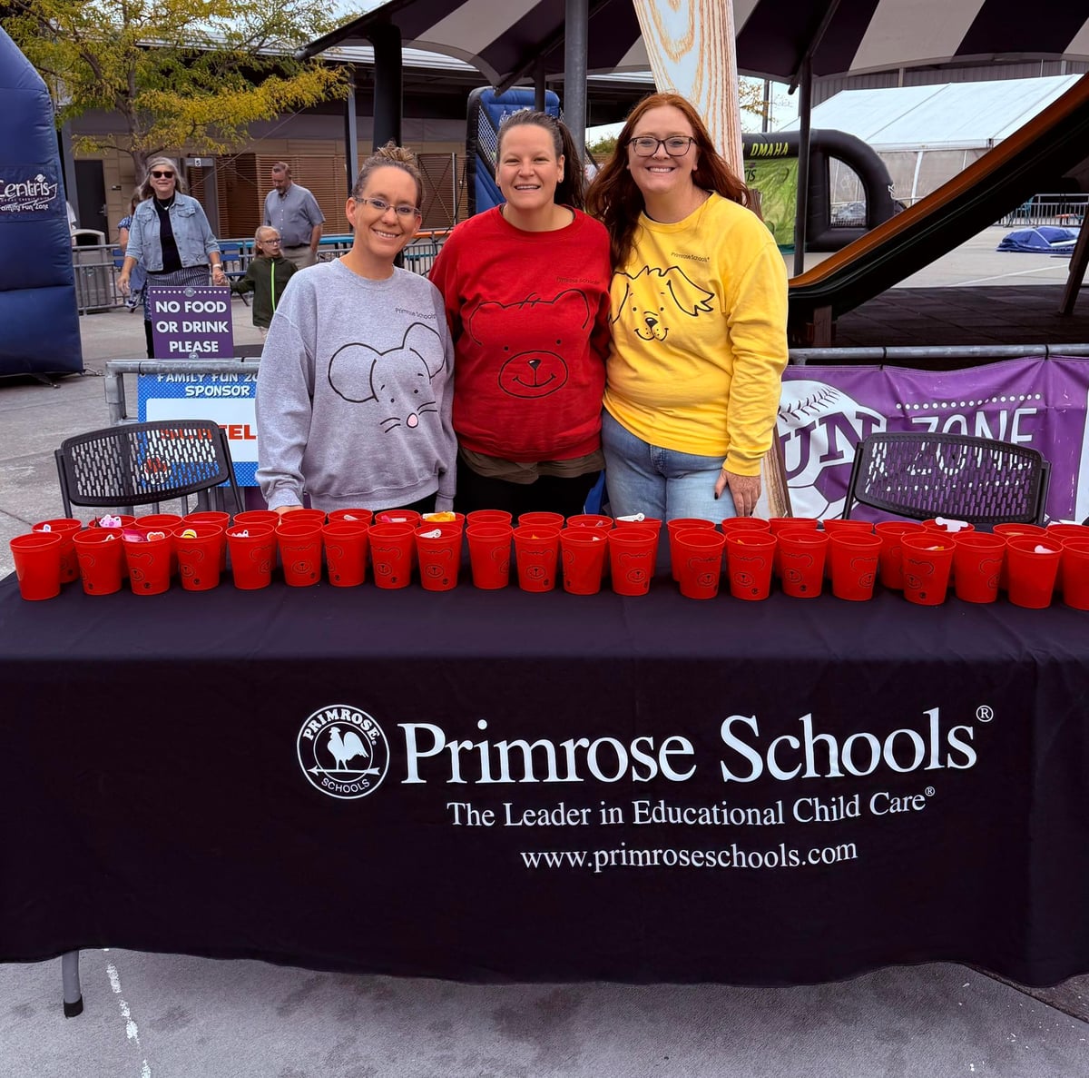 Pictured are three staff members in front of table set up with gifts.