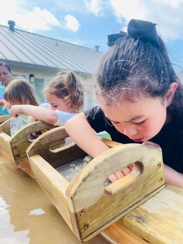 group of pre-kindergarten kids mining for gems and crystals during the fun and educational STEM summer program at the best pre-k preschool near me, fort worth, saginaw, eagle mountain, texas