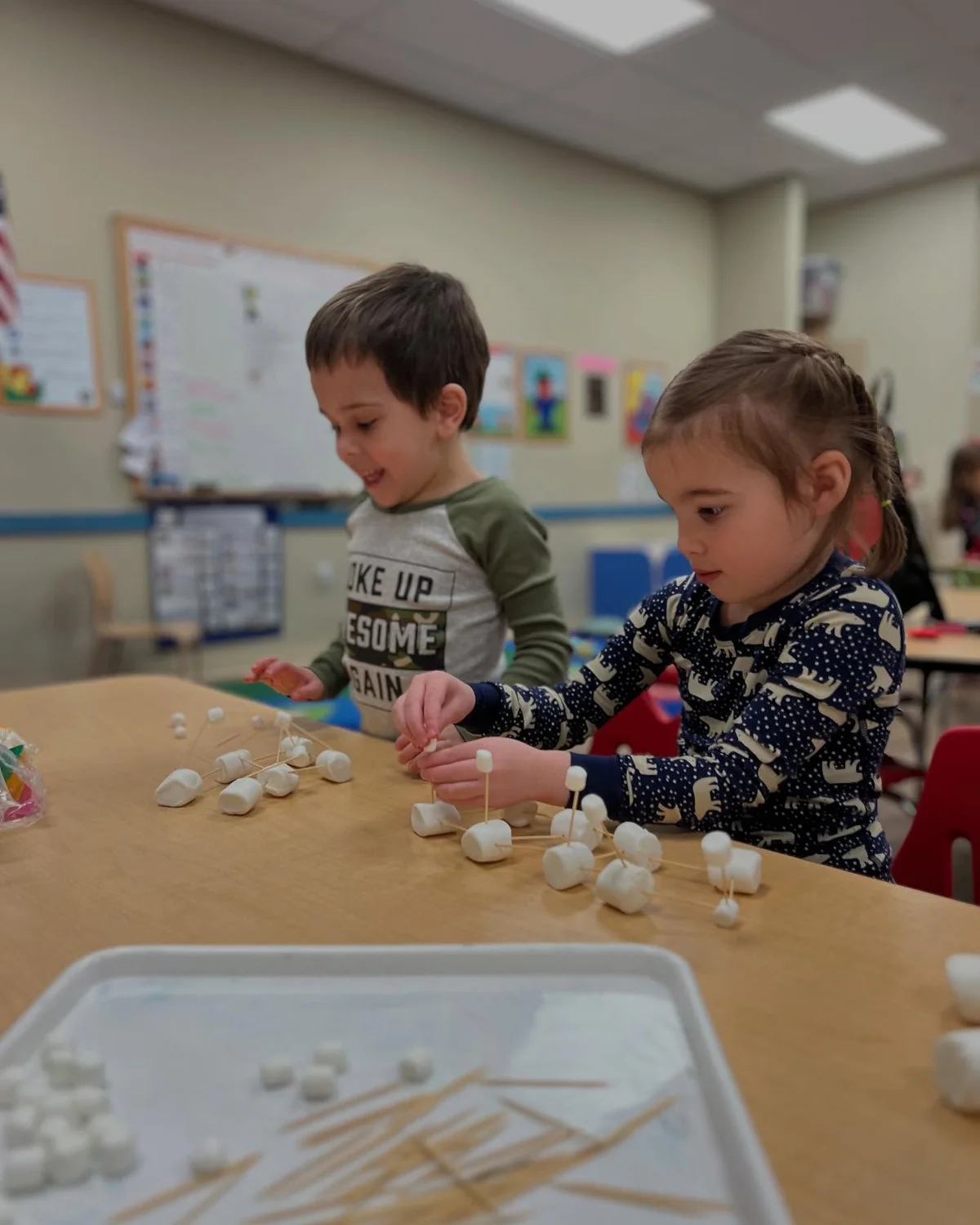 Pre-K students learning to build structures using marshmallows and toothpicks, STEAM, engineering, sequencing