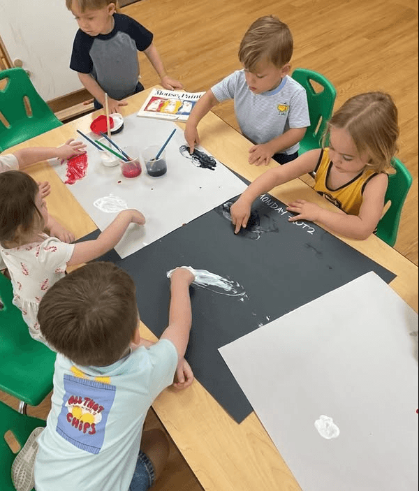 children doing a finger painting activity