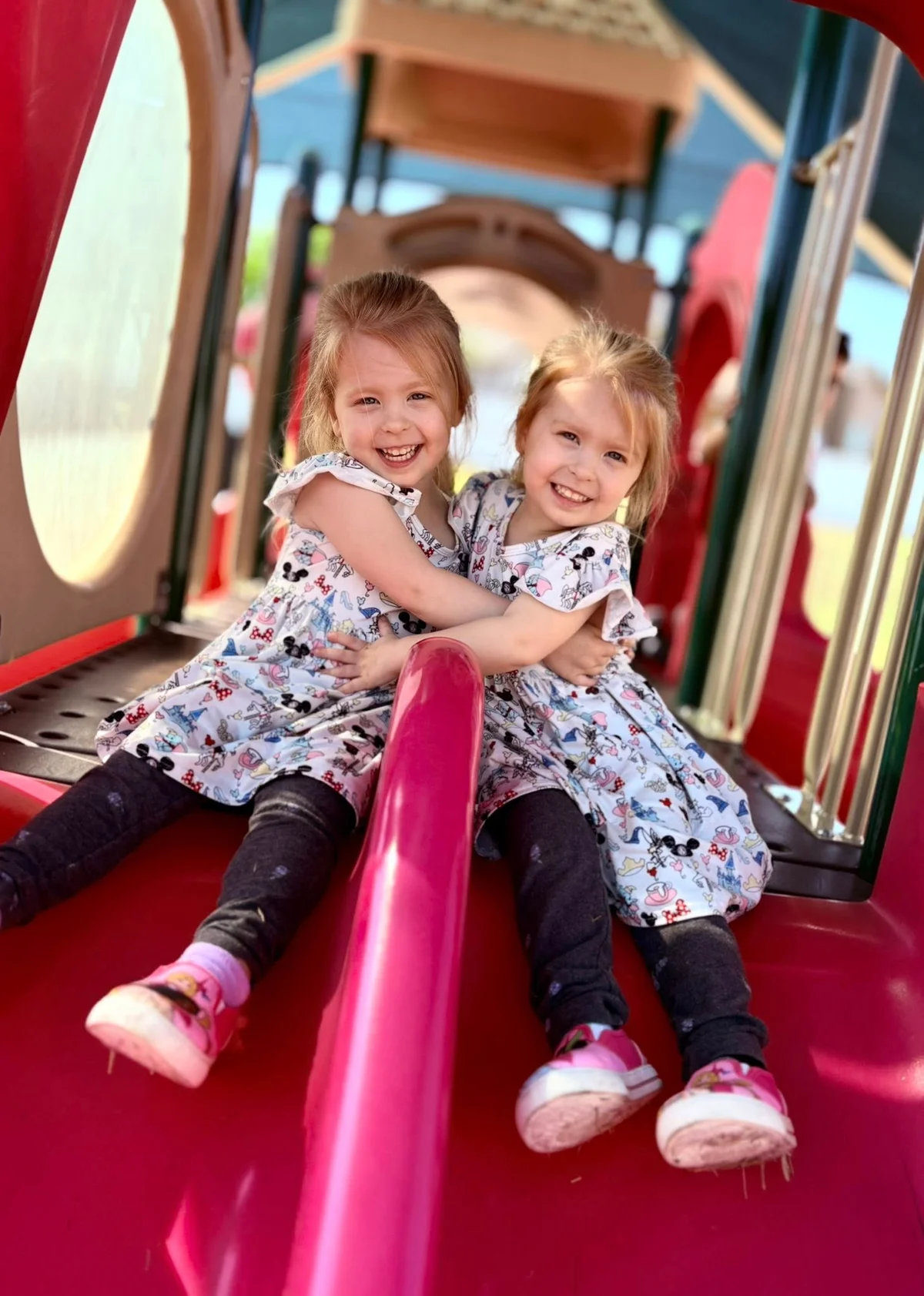 twin toddler preschool girls playing on the slides having fun at the best preschool, early childcare, daycare near me in saginaw fort worth texas