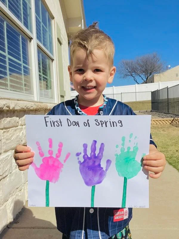 preschool child holding spring art picture at best private preschool daycare near me in fort worth, saginaw, texas