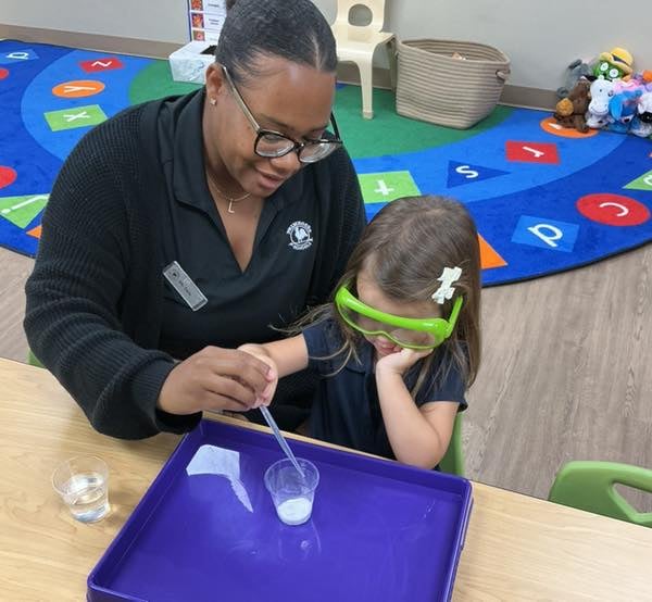 woman and girl performing science experiment