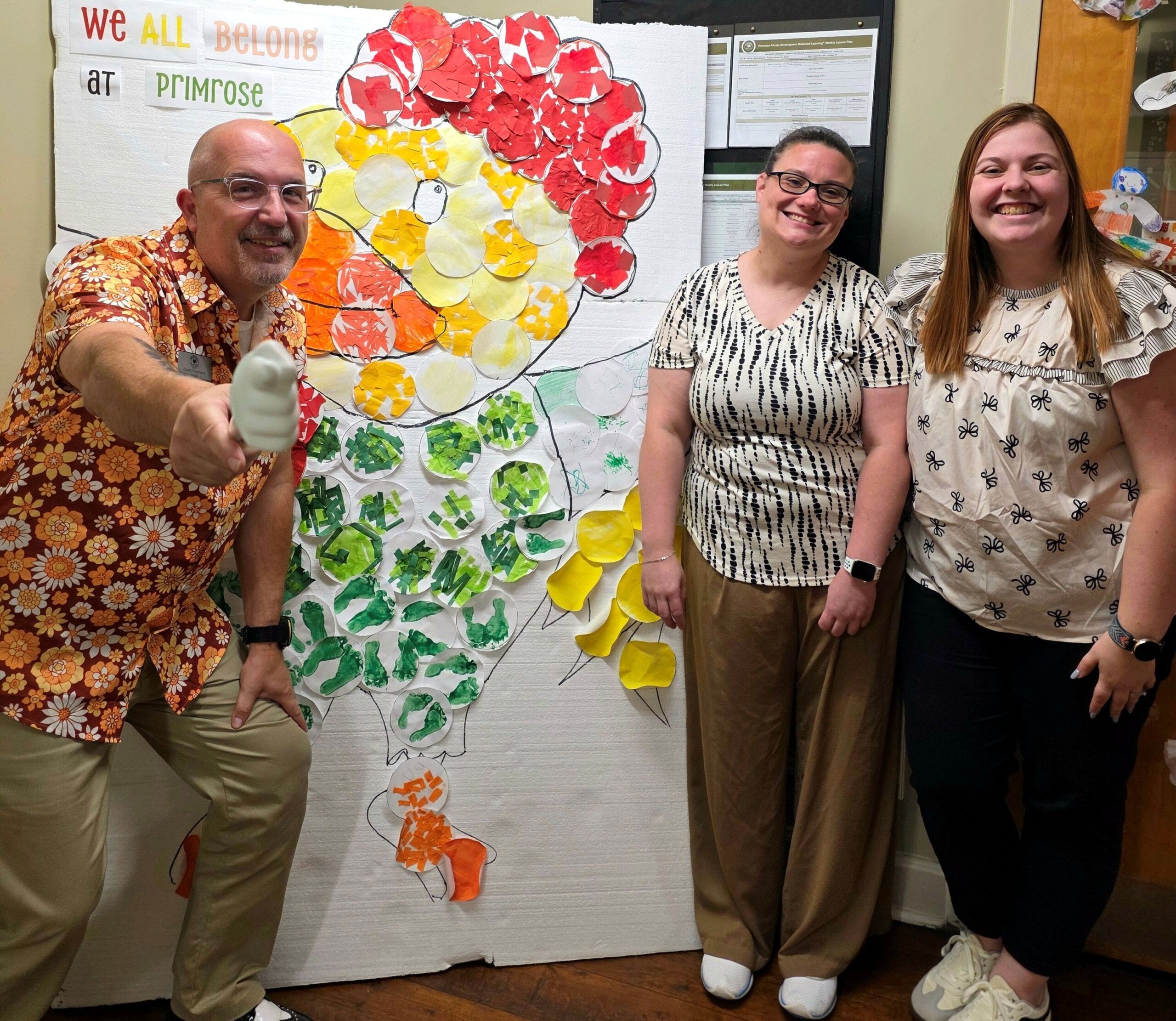 three school admins posing and smiling with Percy rooster belongingness project