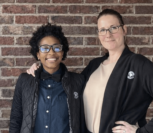 teachers at a group outing holding their artwork and smiling